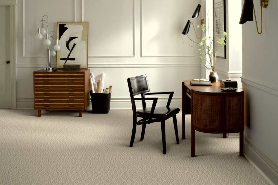 beige patterned carpet in mid century modern home office with wood furniture